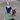 A low-angle view shows the Drain Incycler Rainbow Color Glass Rig with a colorful glass body and circular base on a gray surface.