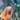A hand holds the white Donut Bear Pipe against a blurred, colorful background, showcasing its compact size and unique shape.