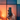 Handheld close-up of a black Pax Flow Vaporizer held upright against a soft, multicolored sunset window background.