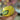 A close-up shot of the Lemon Pipe held in a hand, showcasing its detailed, curved design against a blurred background.