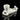 A studio shot displays the Pot Head Pipe, a white ceramic pipe shaped like a head with a glossy finish and reflective surface.