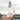A hand holds the Blastoff Rocket Bong, showcasing its playful design against a blurred cityscape backdrop.
